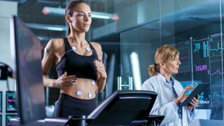 A woman running on a treadmill and a woman tracking heartbeat