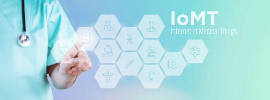 Graphic of IoMT: Internet of Medical Things. Graphic of healthcare worker pointing at various healthcare-related icons on a hexagon grid.
