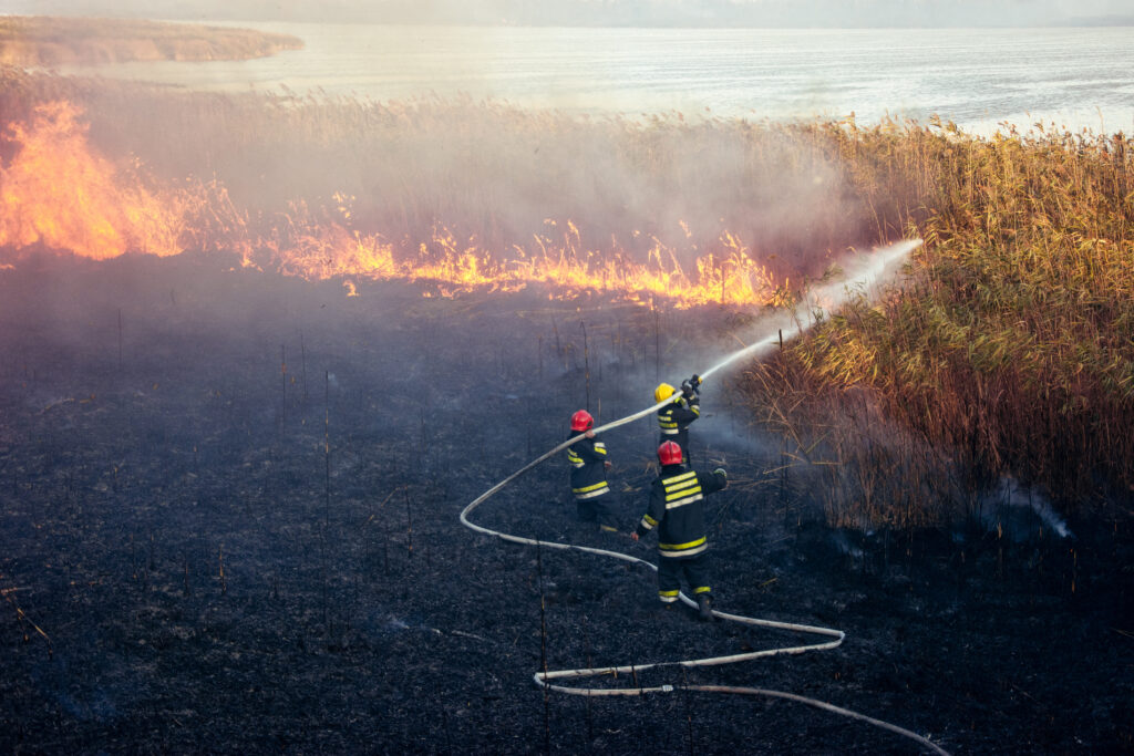 Wildland firefighter using wearable exposure-monitoring sensors during field operations